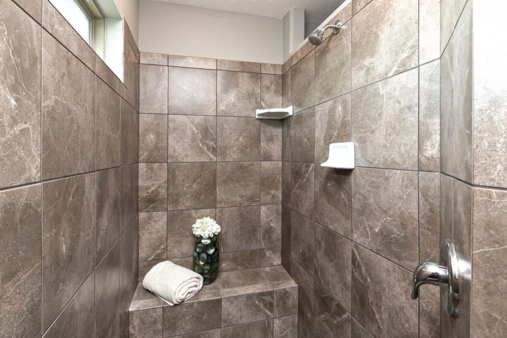 Custom walk-in tile shower in Omaha home by Regency Homes